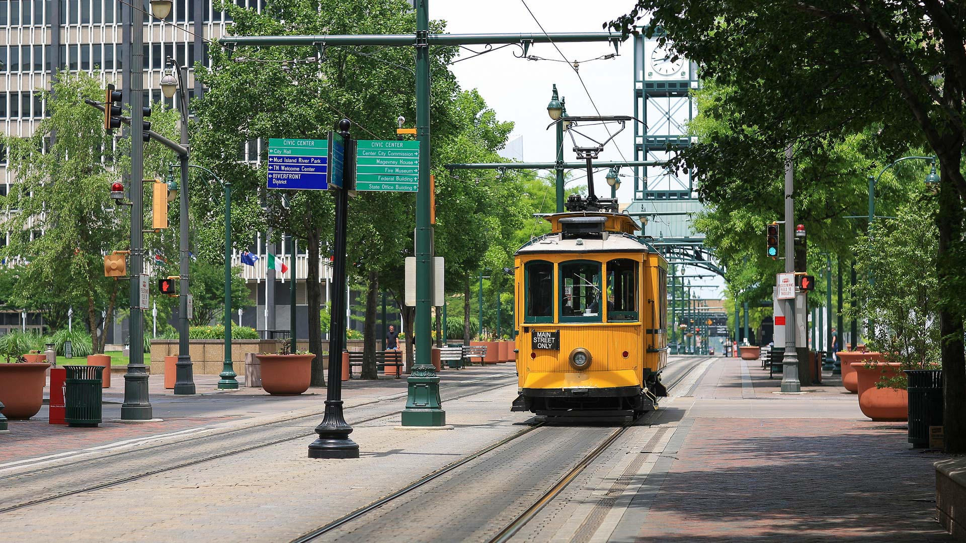 a yellow trolley on a street