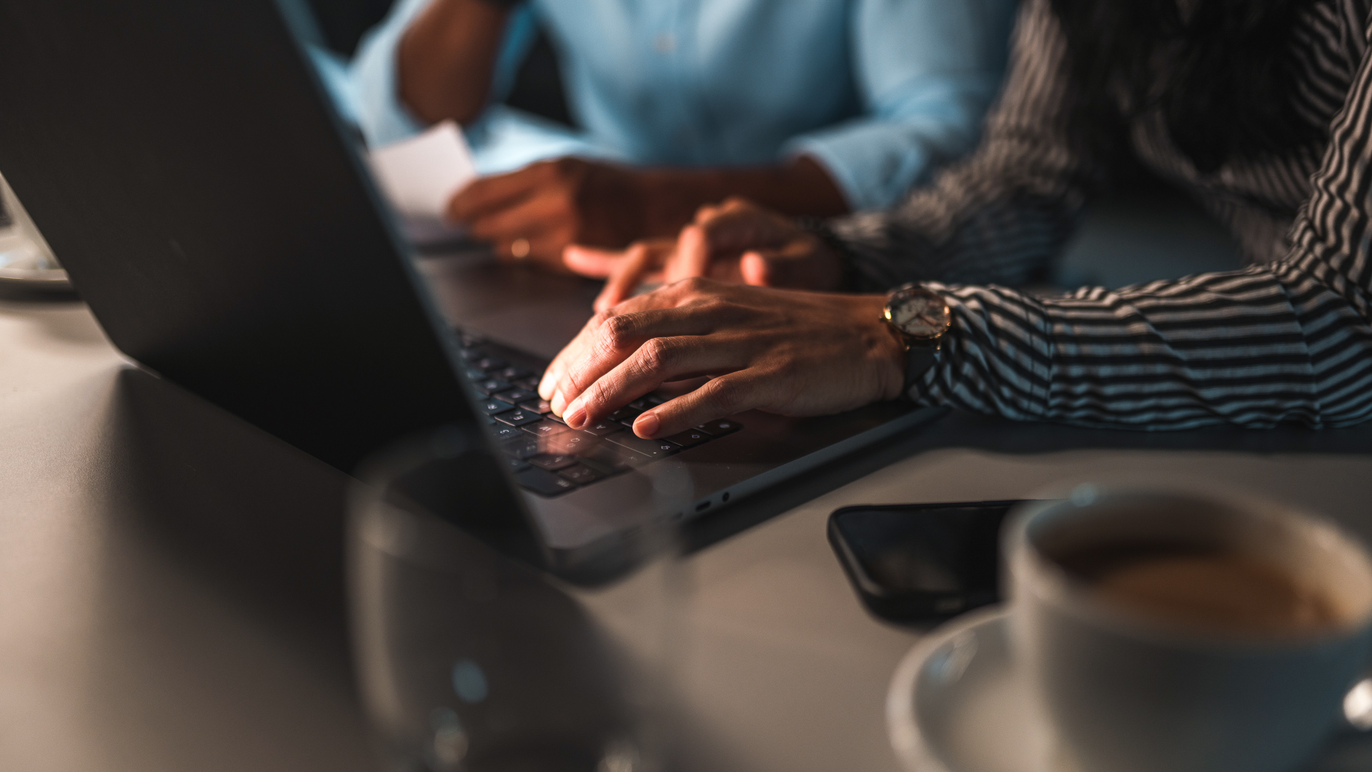 a close up of hands on a laptop