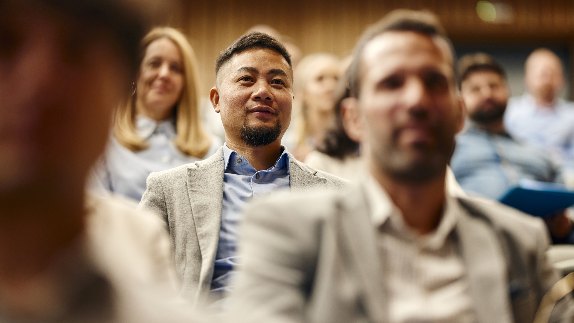 a man sitting in a room with other people