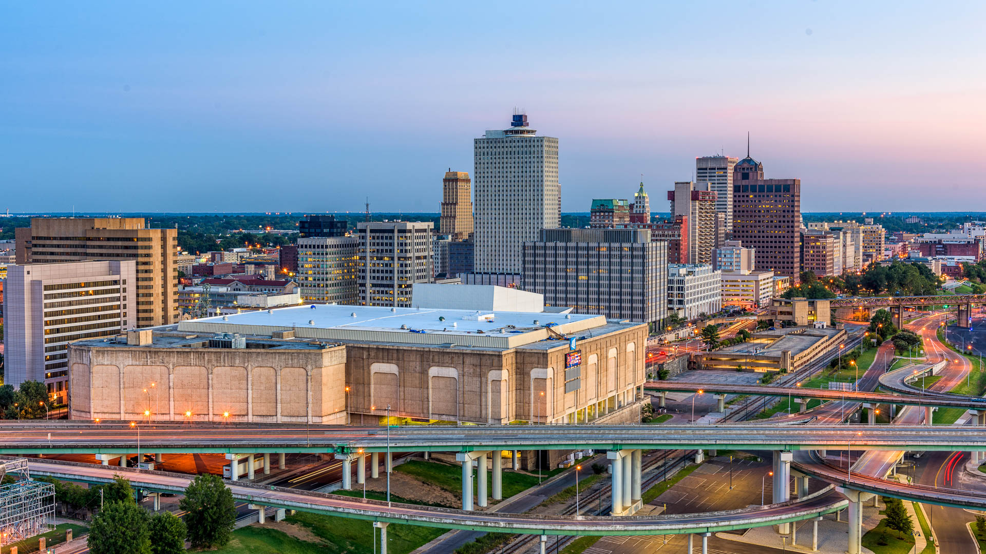 a city with a large building and a highway