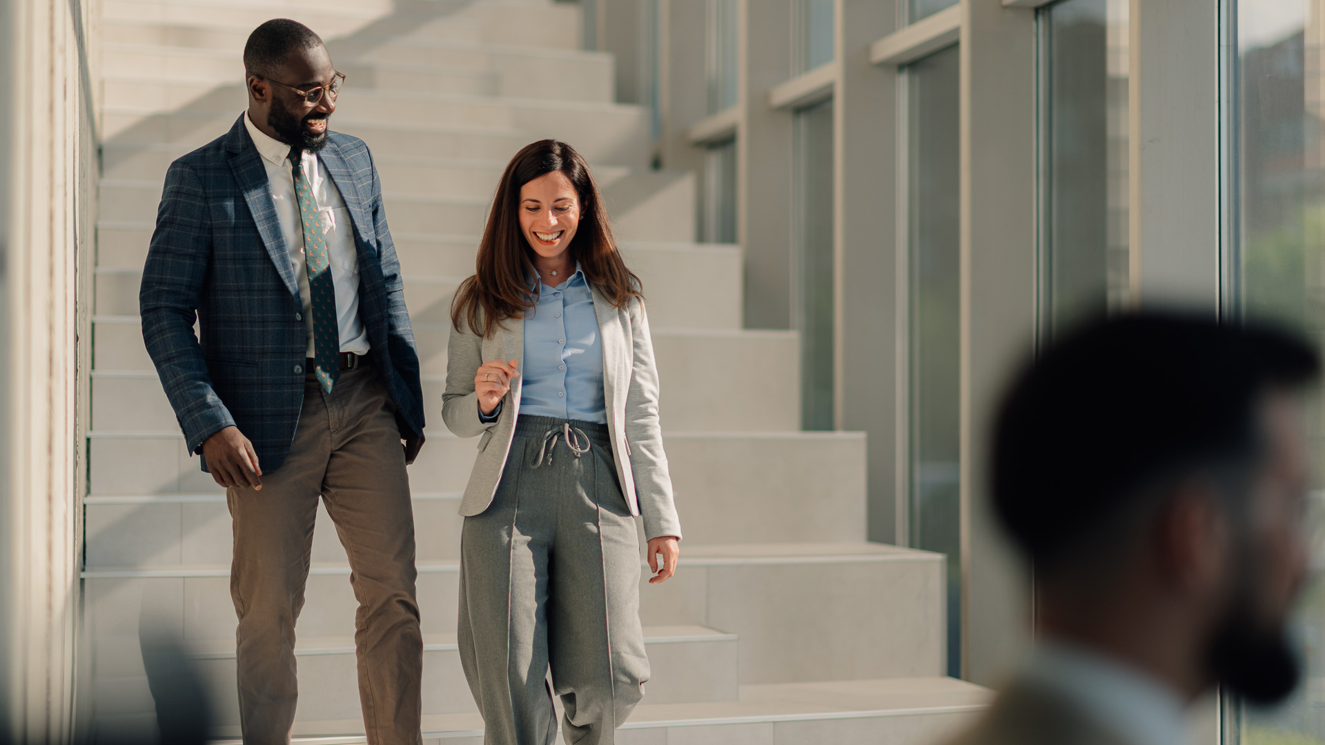 a man and woman walking down stairs