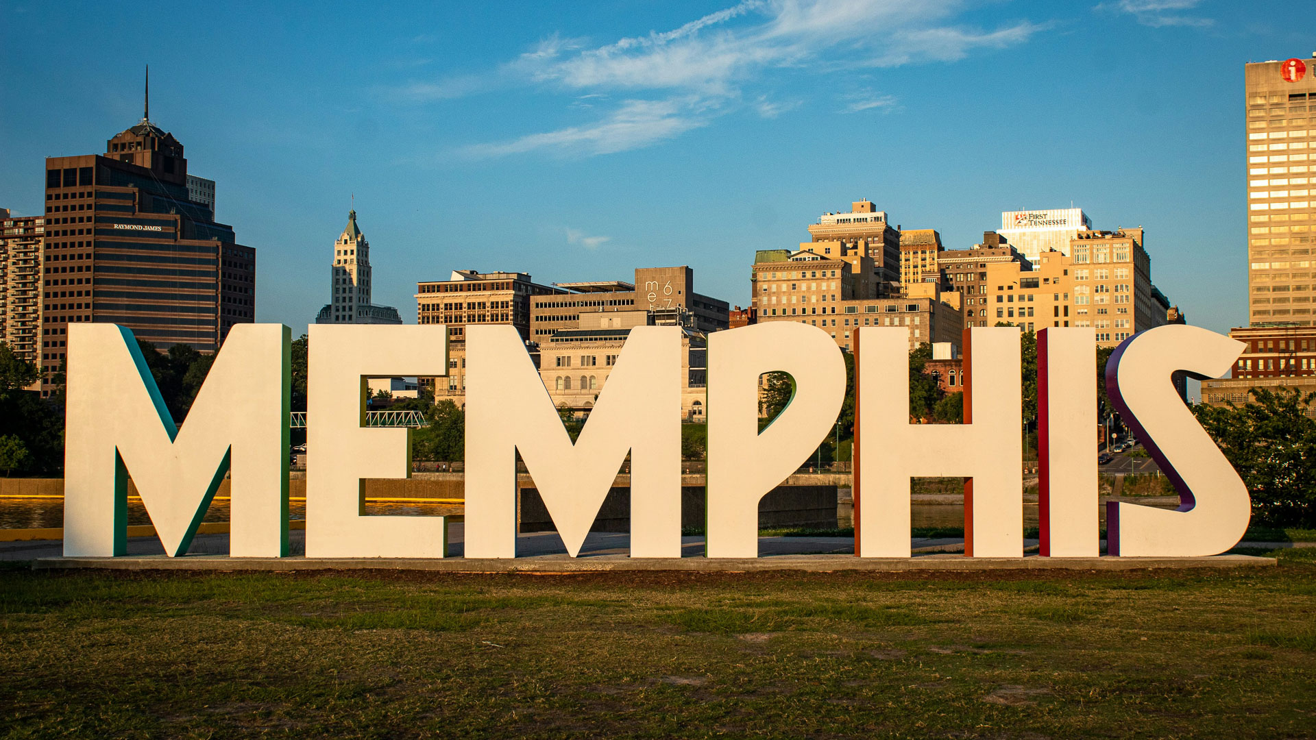 a large white sign in front of a city