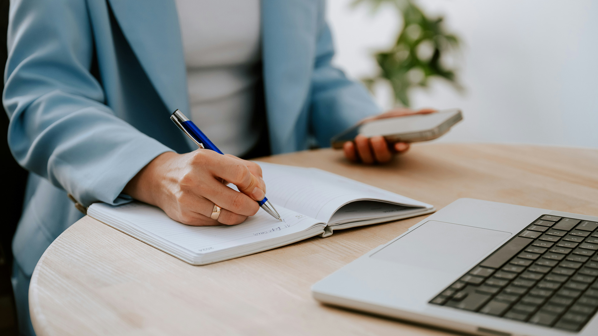 a person writing on a notebook