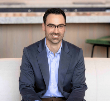 a man in a suit sitting on a couch