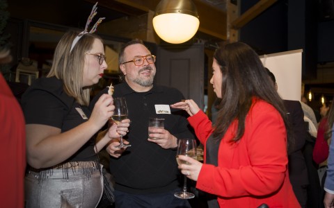 a group of people holding glasses