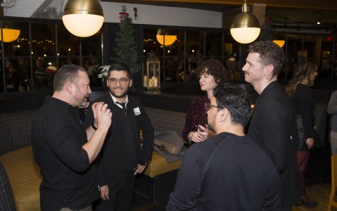 a group of people standing around each other