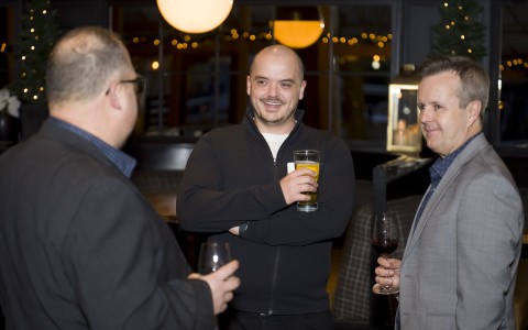 a group of men holding drinks