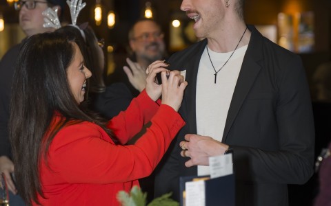 a woman holding a man's hand