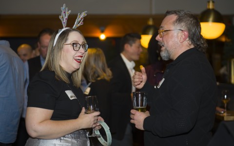 a man and woman talking and drinking