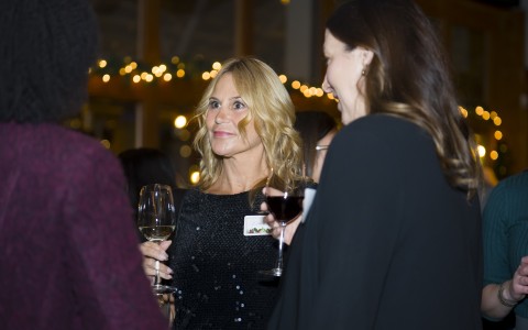 a group of women holding wine glasses