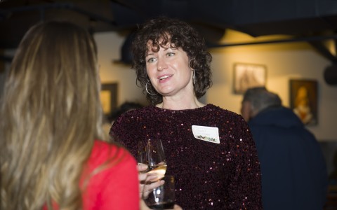 a woman holding a wine glass