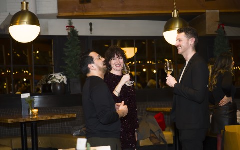 a group of people holding wine glasses