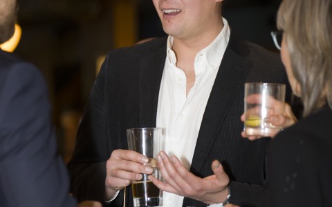 a man holding a glass of beer