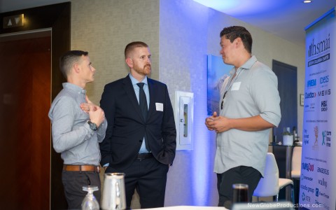 a group of men standing in a room
