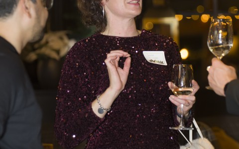 a woman holding wine glasses