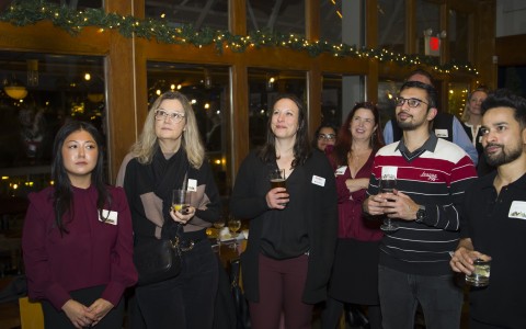 a group of people standing in a room with drinks