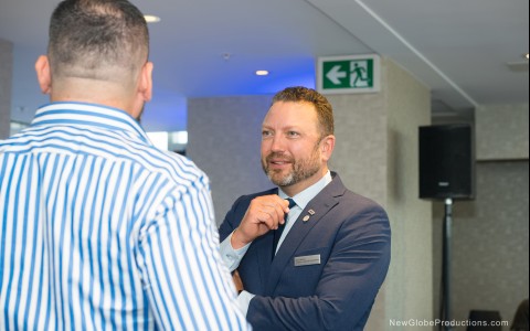 a man in a suit talking to another man