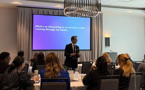 a man in a suit giving a presentation to a group of people