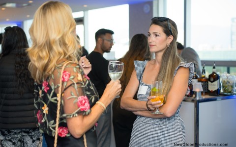 a group of women standing in a room with drinks