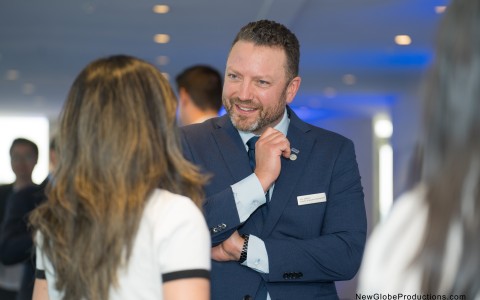 a man in a suit fixing a tie