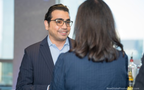 a man in a suit talking to a woman