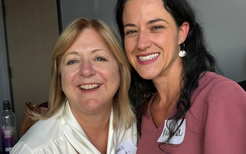 a couple of women smiling for a photo