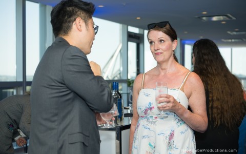 a man and woman standing at a bar