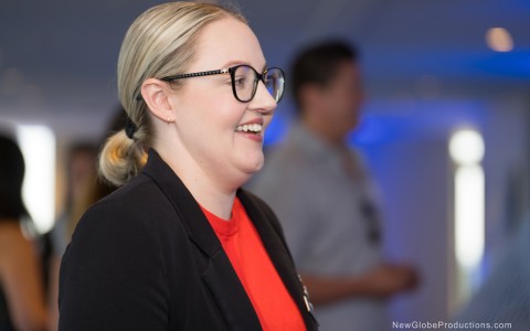 a woman in glasses smiling