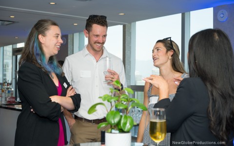 a group of people talking and drinking