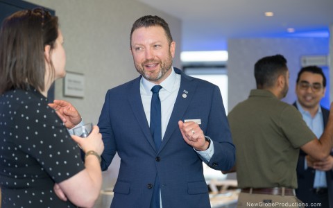 a man in a suit and tie talking to a woman