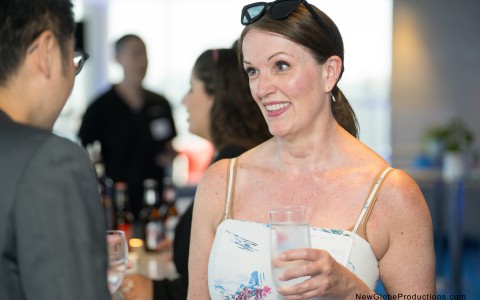 a woman holding a glass of water