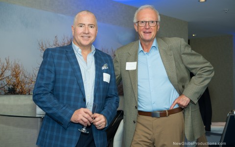 two men standing together smiling