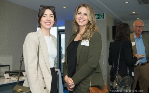 two women standing together smiling