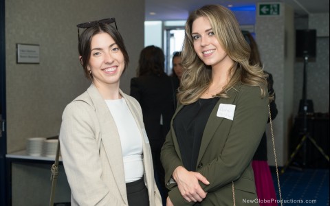 two women standing together smiling