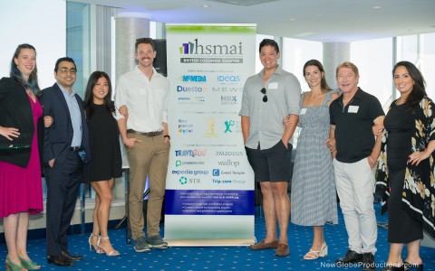 a group of people standing in front of a sign