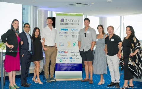 a group of people standing in front of a sign