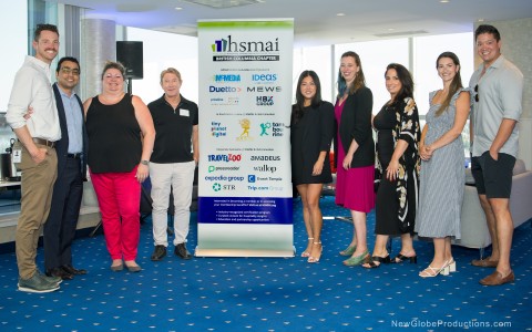 a group of people standing in front of a sign