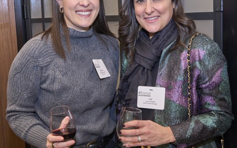 two women holding wine glasses