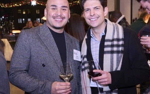 two men holding wine glasses