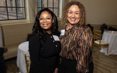 two women standing together smiling