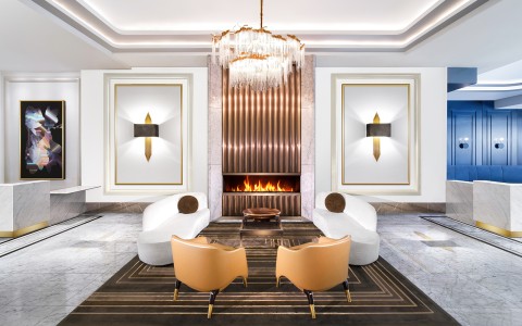 a room with a fireplace and white chairs