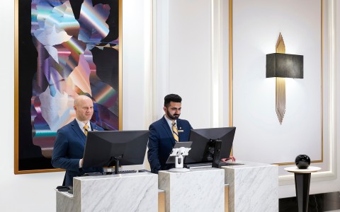 a group of men standing at a desk
