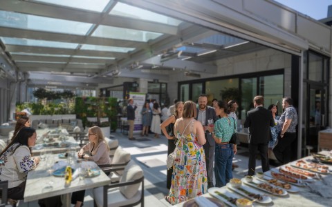 a group of people standing around a table