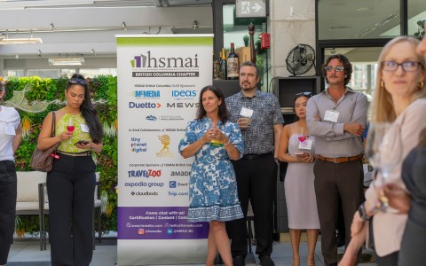 a group of people standing in front of a sign