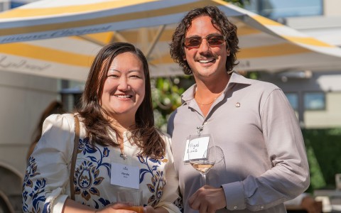 a man and woman holding wine glasses