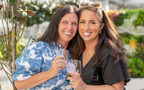 two women holding wine glasses