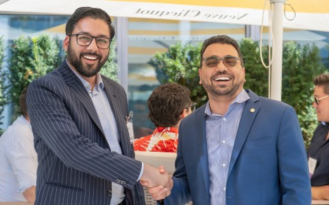two men shaking hands outside