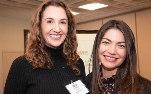 a couple of women smiling at camera