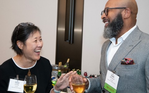 a man and woman holding wine glasses