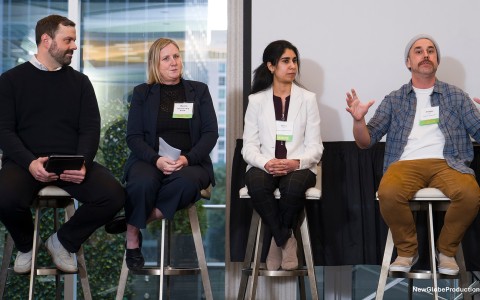 a group of people sitting on stools